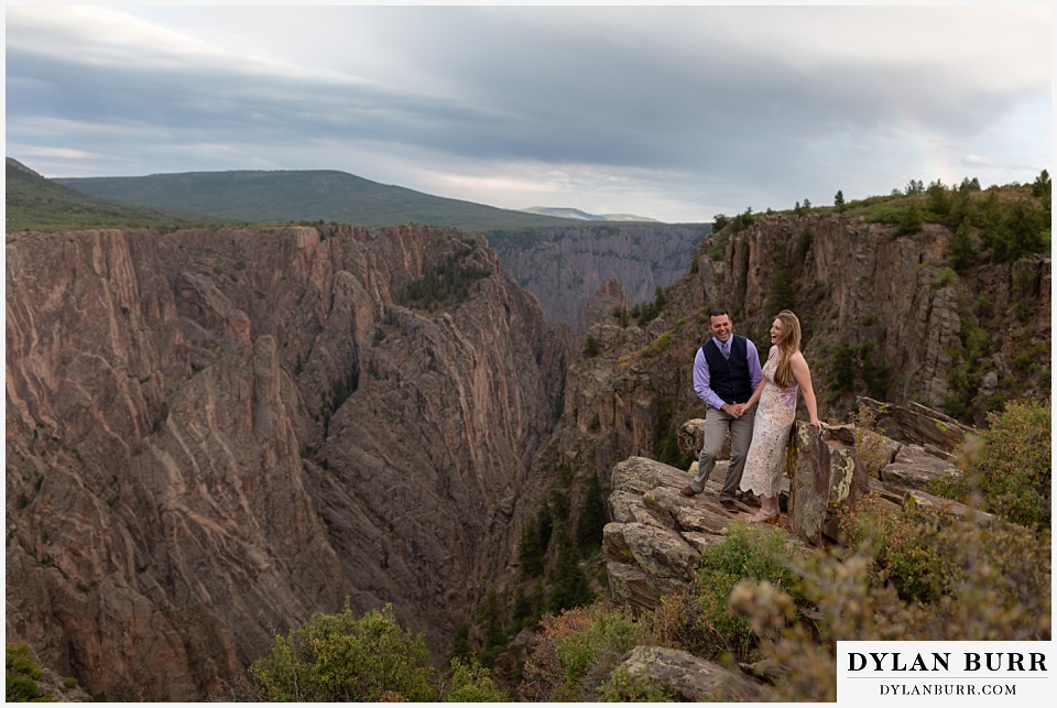 black canyon colorado elopement wedding adventure bride and groom having fun on canyon ledge