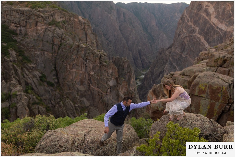 black canyon colorado elopement wedding adventure bride and groom hiking on rocks