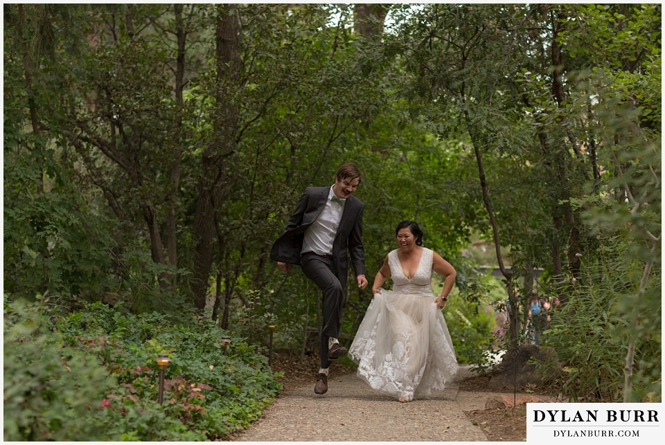 denver botanic gardens wedding colorado woodland mosaic bride groom trying to skip together