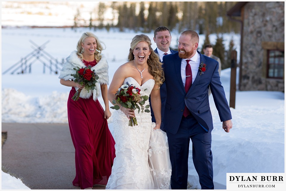 devils thumb ranch wedding in winter bridal party walking in snow