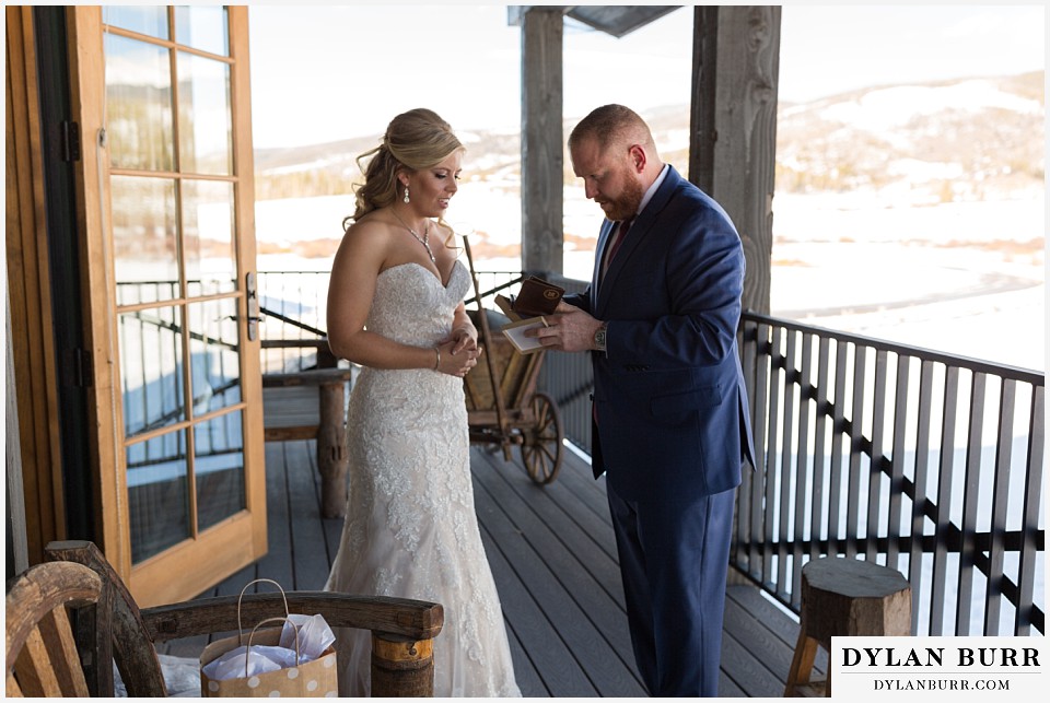 devils thumb ranch wedding in winter first look grooms gift