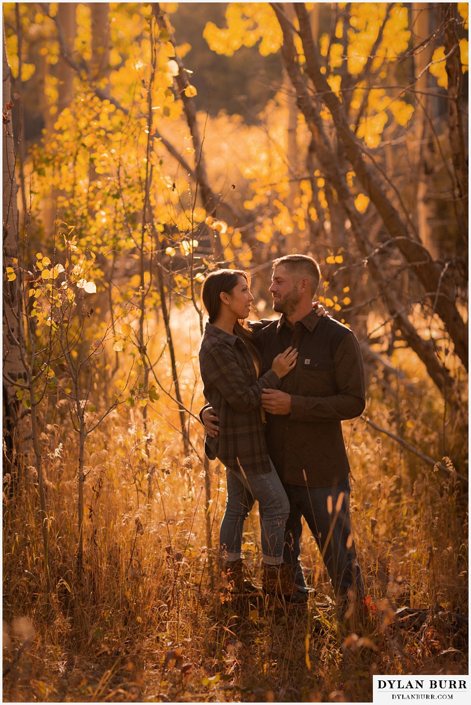 engagement photos golden colorado photographer couple standing together in aspen trees during fall in colorado
