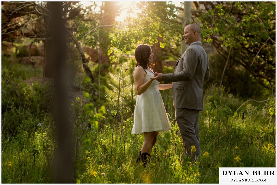 rocky mountain estes park engagement session standing in meadow with aspen trees