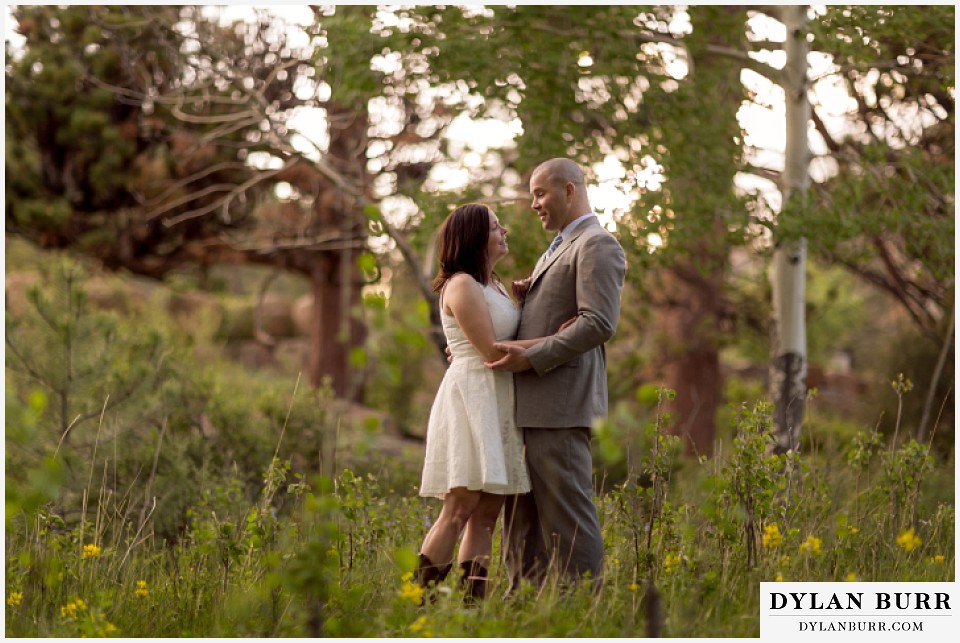 rocky mountain estes park engagement session standing together in a meadow of aspen trees