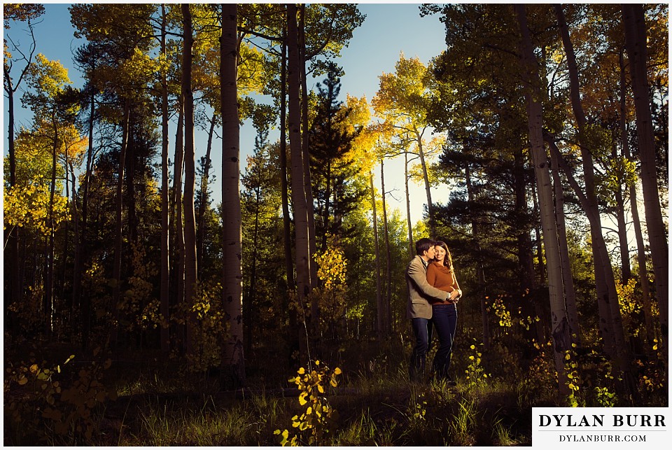 how to prepare for my engagement session couple standing in aspen trees in early fall