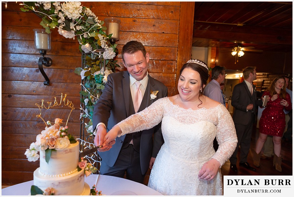 crystal rose wedding golden colorado bride and groom cutting cake