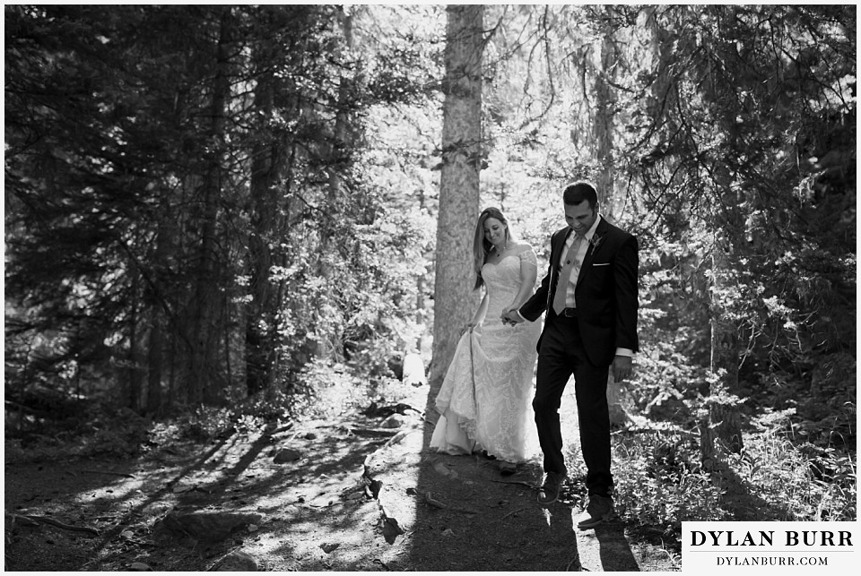uncompahgre national forest colorado elopement wedding adventure bride and groom walk together through pine trees