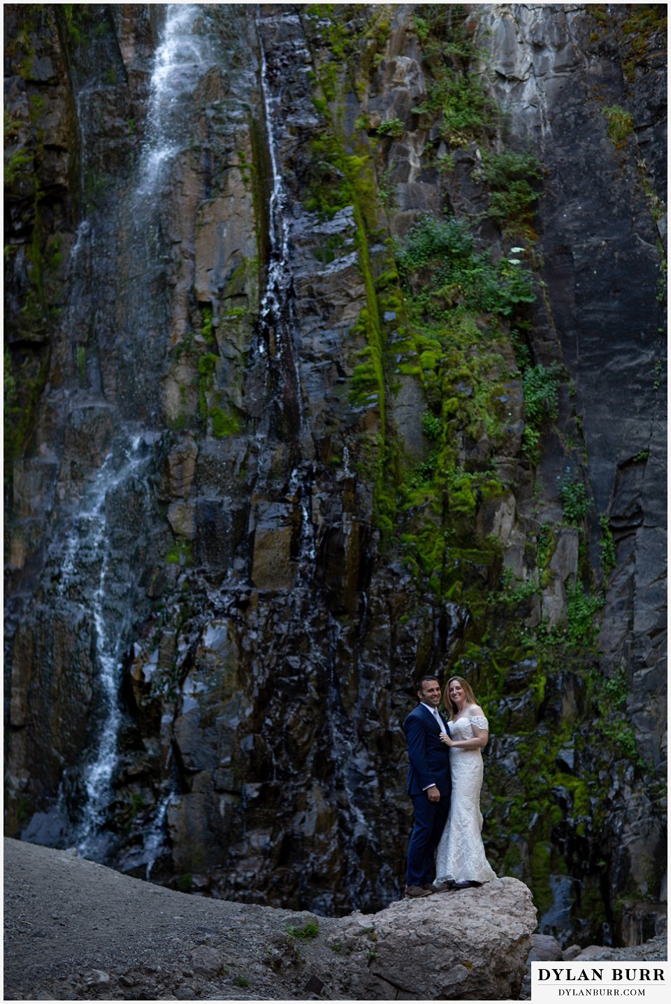uncompahgre national forest colorado elopement wedding adventure bride and groom together on a rock near a waterfall