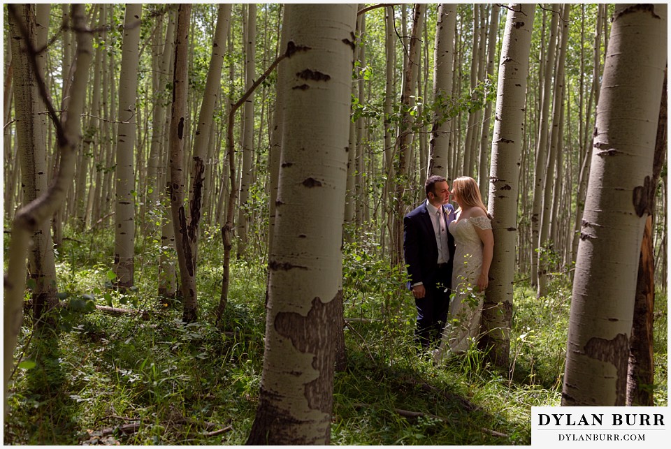 uncompahgre national forest colorado elopement wedding adventure bride and groom kissing in the aspen trees