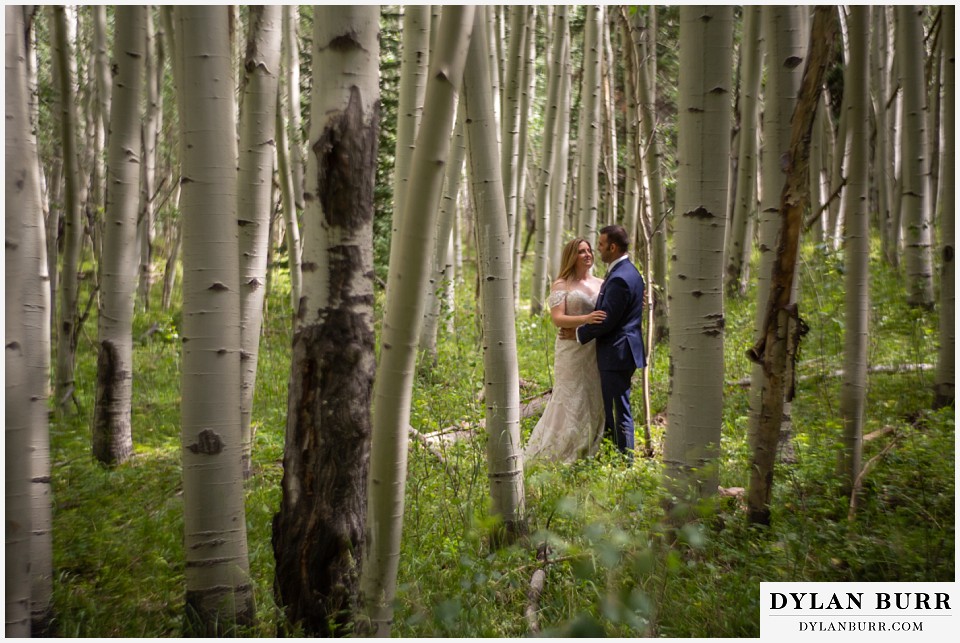 uncompahgre national forest colorado elopement wedding adventure bride and groom stading amoung the aspen trees