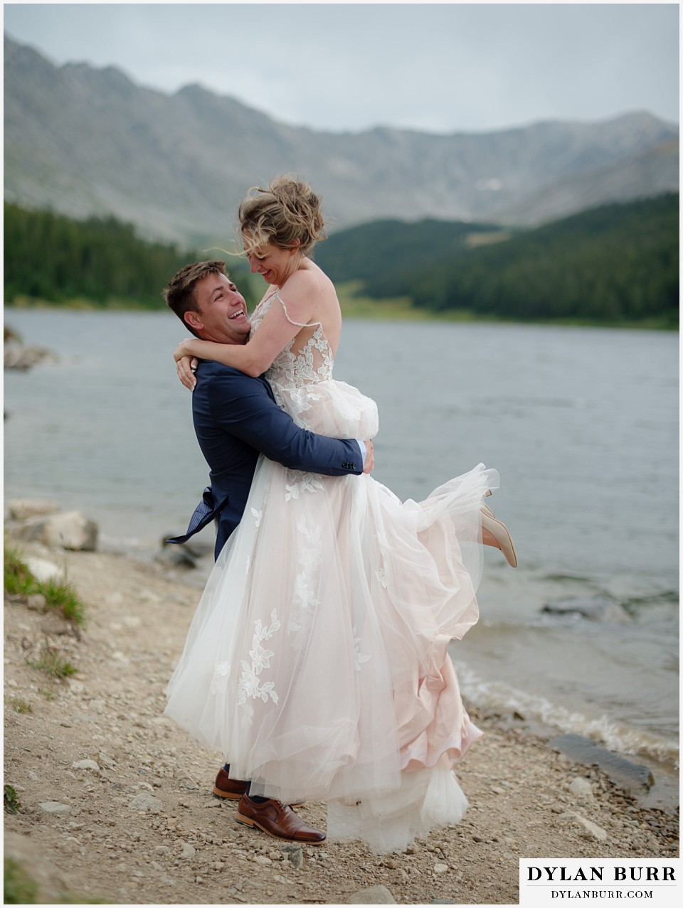 super happy married couple by a alpine lake in the colorado mountains