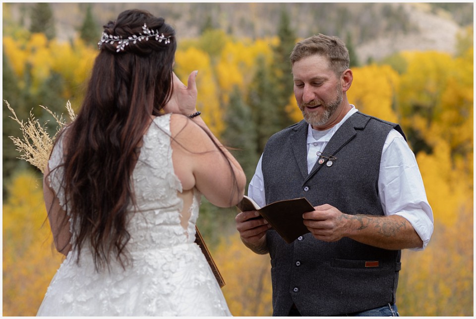 adventure elopement western colorado groom reading his vows to his bride
