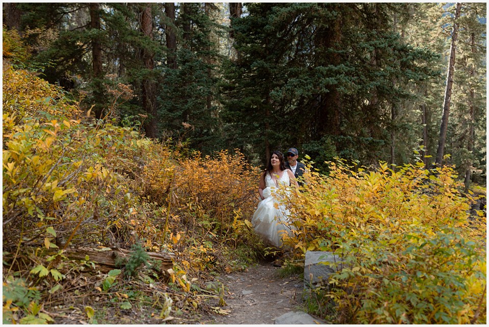 adventure elopement western colorado bride and groom on mountain trail in the falls