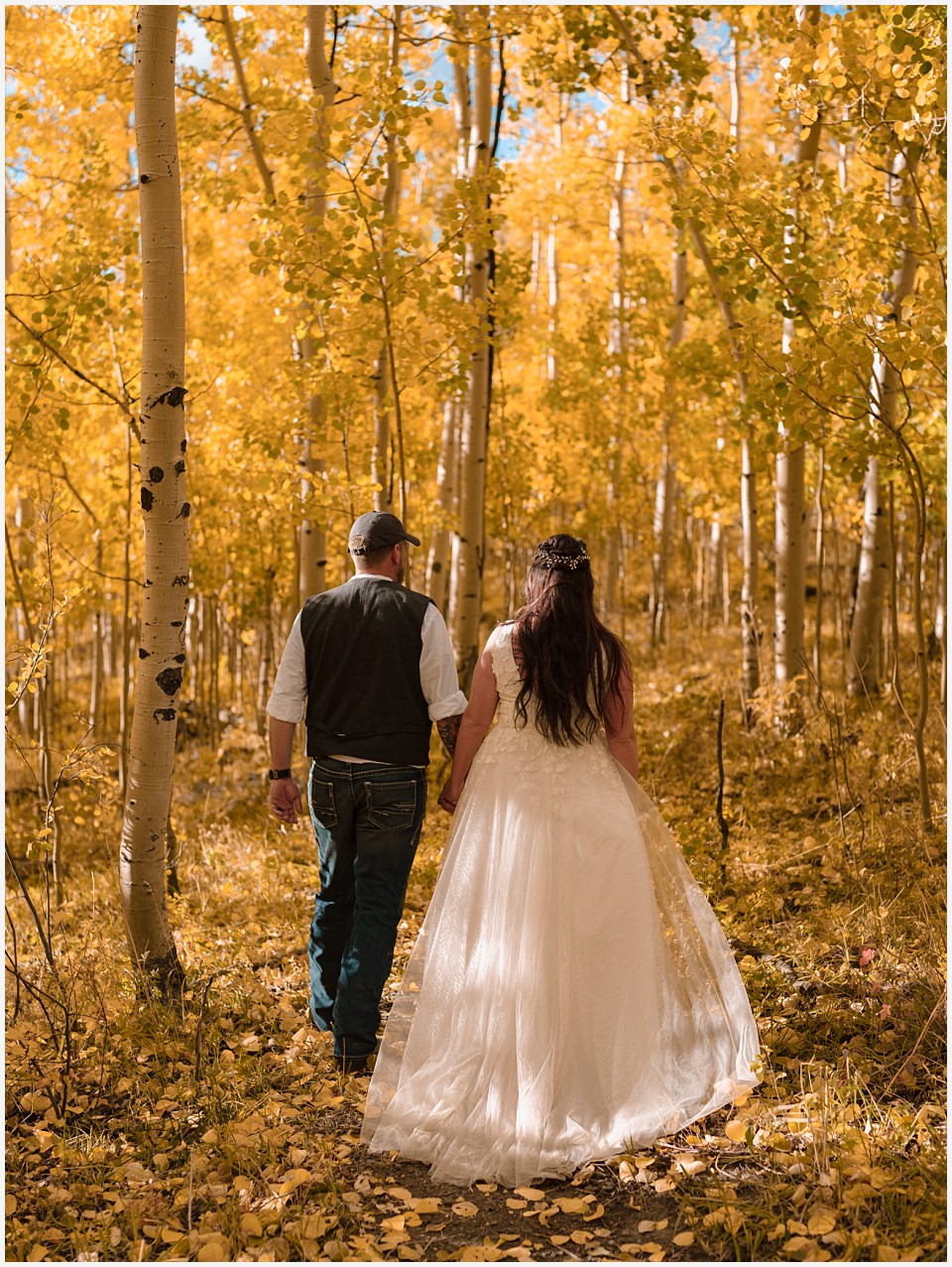 adventure elopement western colorado bride and groom surrounded by gold aspens