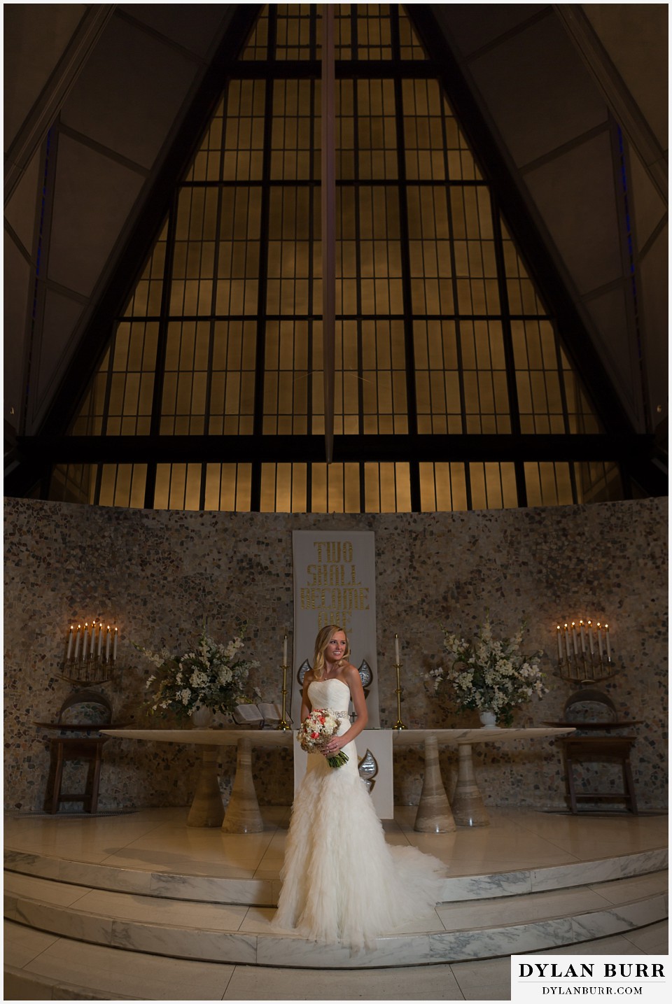 air force academy wedding bride standing alone in cadet chapel with ominus sky