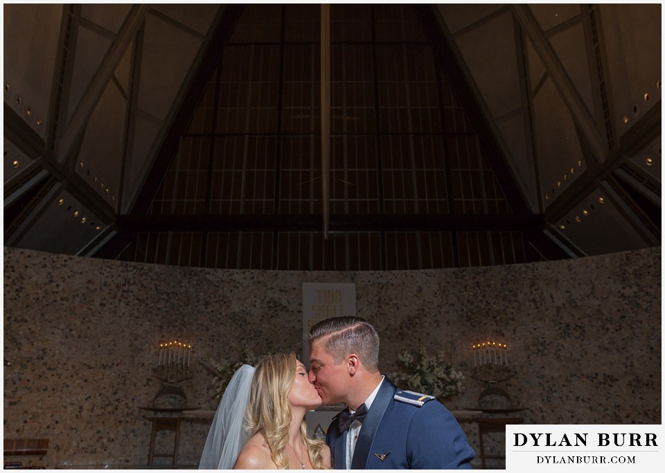 air force academy wedding bride and groom kissing in cadet chapel