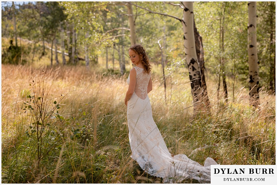 antler basin ranch wedding bride in field of grass and aspen trees