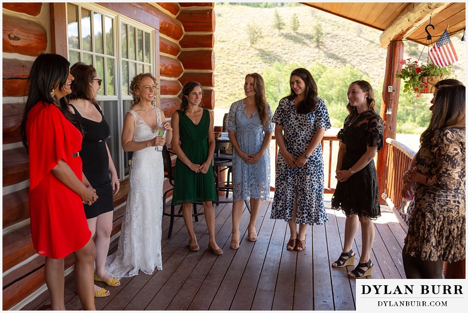 bride, family and bridesmaids, on cabin porch during tisch