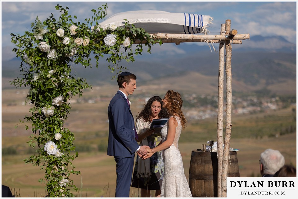 bride and groom exchaning vows Antler Basin Ranch wedding