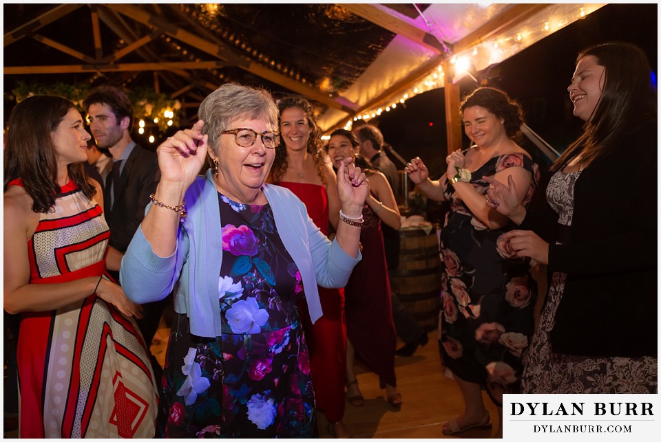 old woman dancing for her song during reception antler basin ranch wedding