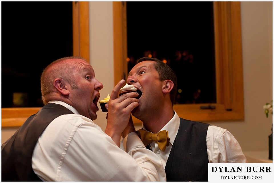 aspen colorado mountain wedding groom sharing cupcake