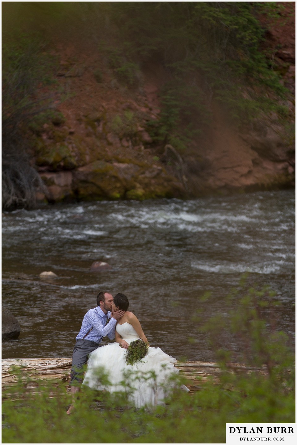 aspen wedding elopement bride and groom kissing over river