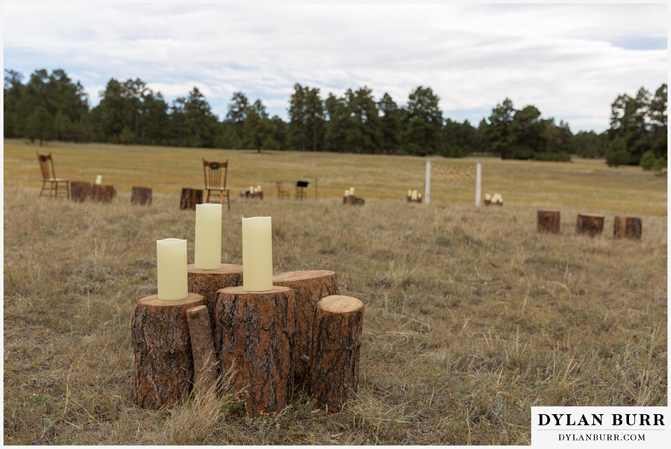 boho backyard colorado wedding ceremony site with tree stumps and candles