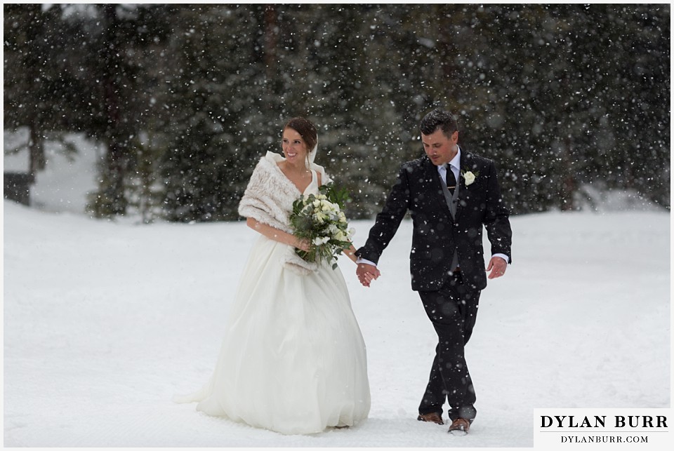 breckenridge nordic center wedding colorado mountain wedding photographer couple walking together in falling snow