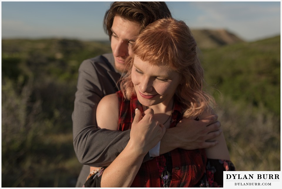 castle rock colorado engagement session having an embrace watching the sunset