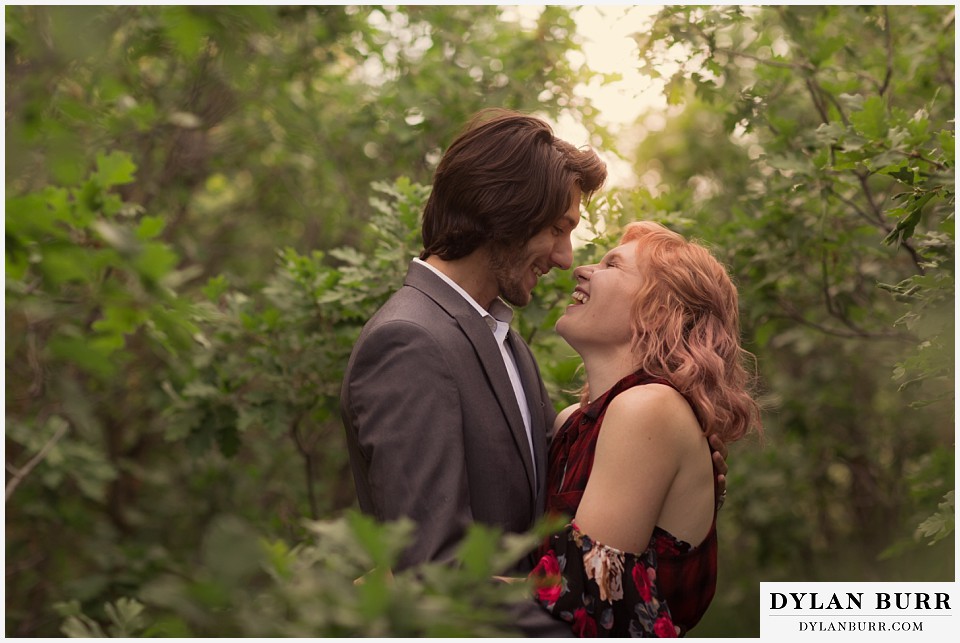 castle rock colorado engagement session laughing in the oak trees