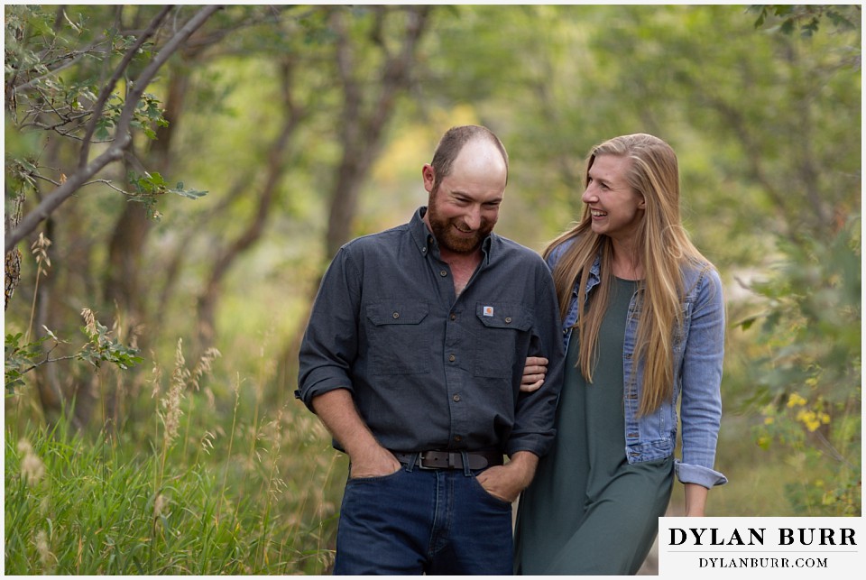 castlewood canyon engagement photos couple laughing in trees