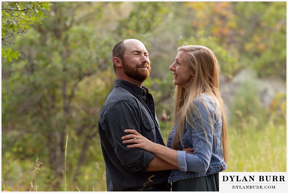 castlewood canyon engagement photos couple standing together and he is surprised