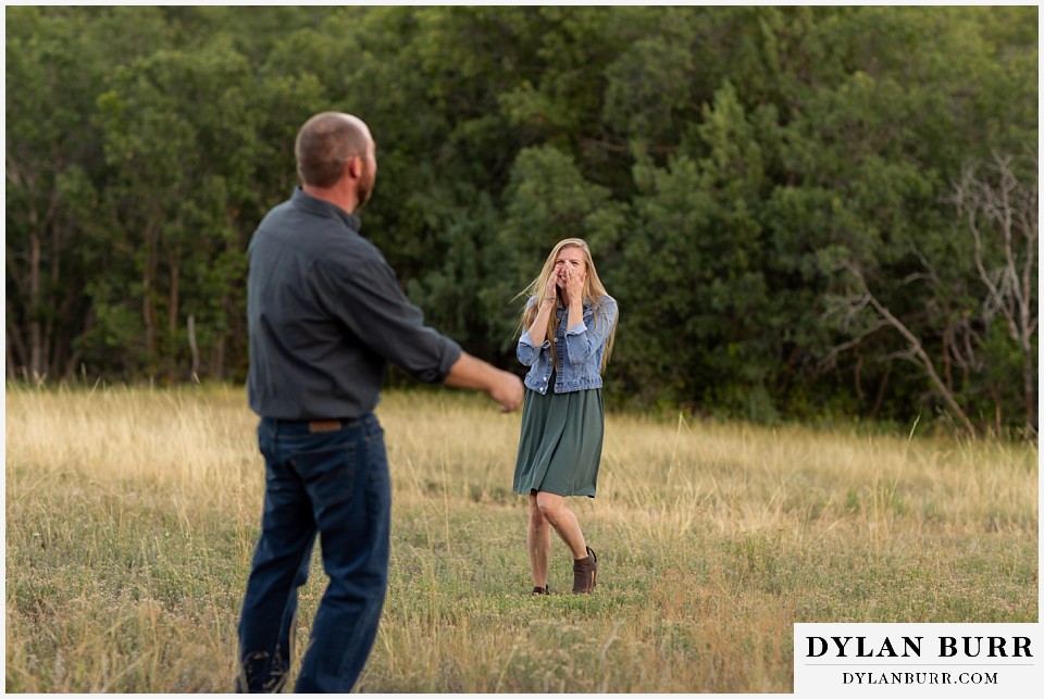castlewood canyon engagement photos couple hide and go seek in meadow