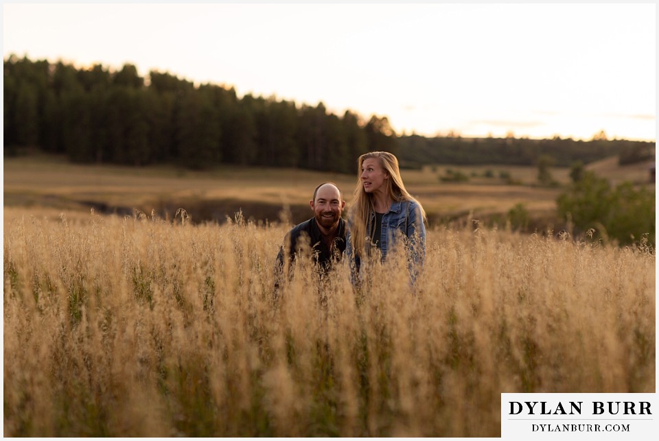 castlewood canyon engagement photos couple popping up out of grass