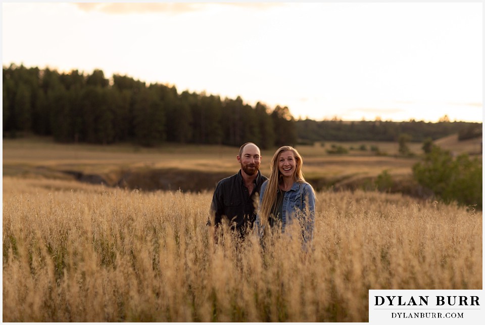 castlewood canyon engagement photos couple laughing while being goofy in grass