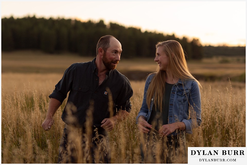 castlewood canyon engagement photos couple having fun together in tall grass meadow