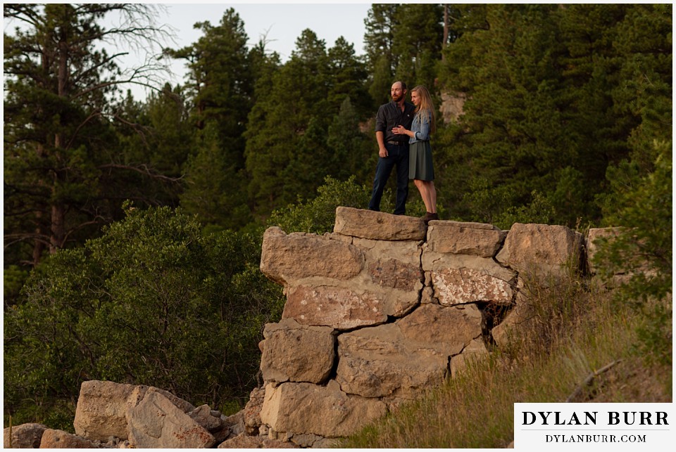 castlewood canyon engagement photos standing together on stone wall