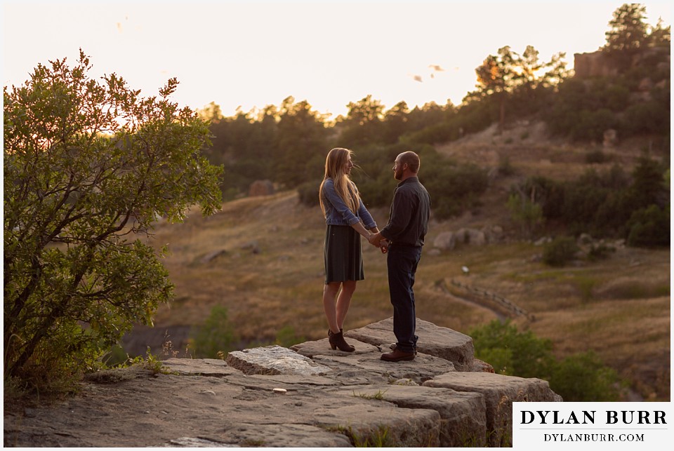 castlewood canyon engagement photos holding hands standing on rocks