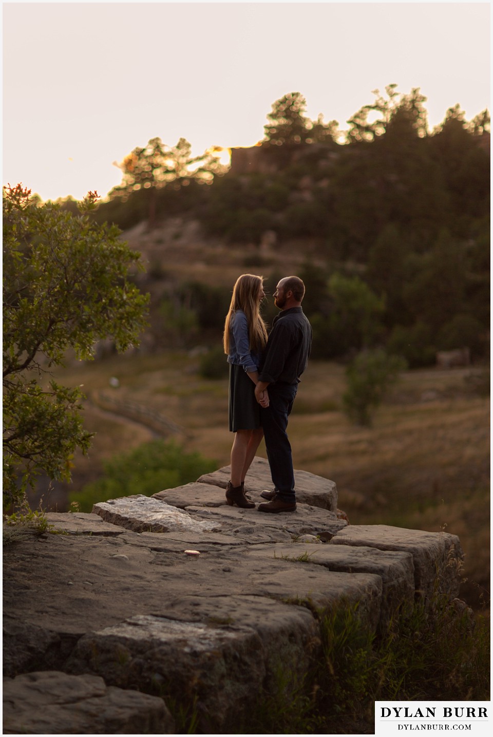 castlewood canyon engagement photos couple loving each other while on stone wall