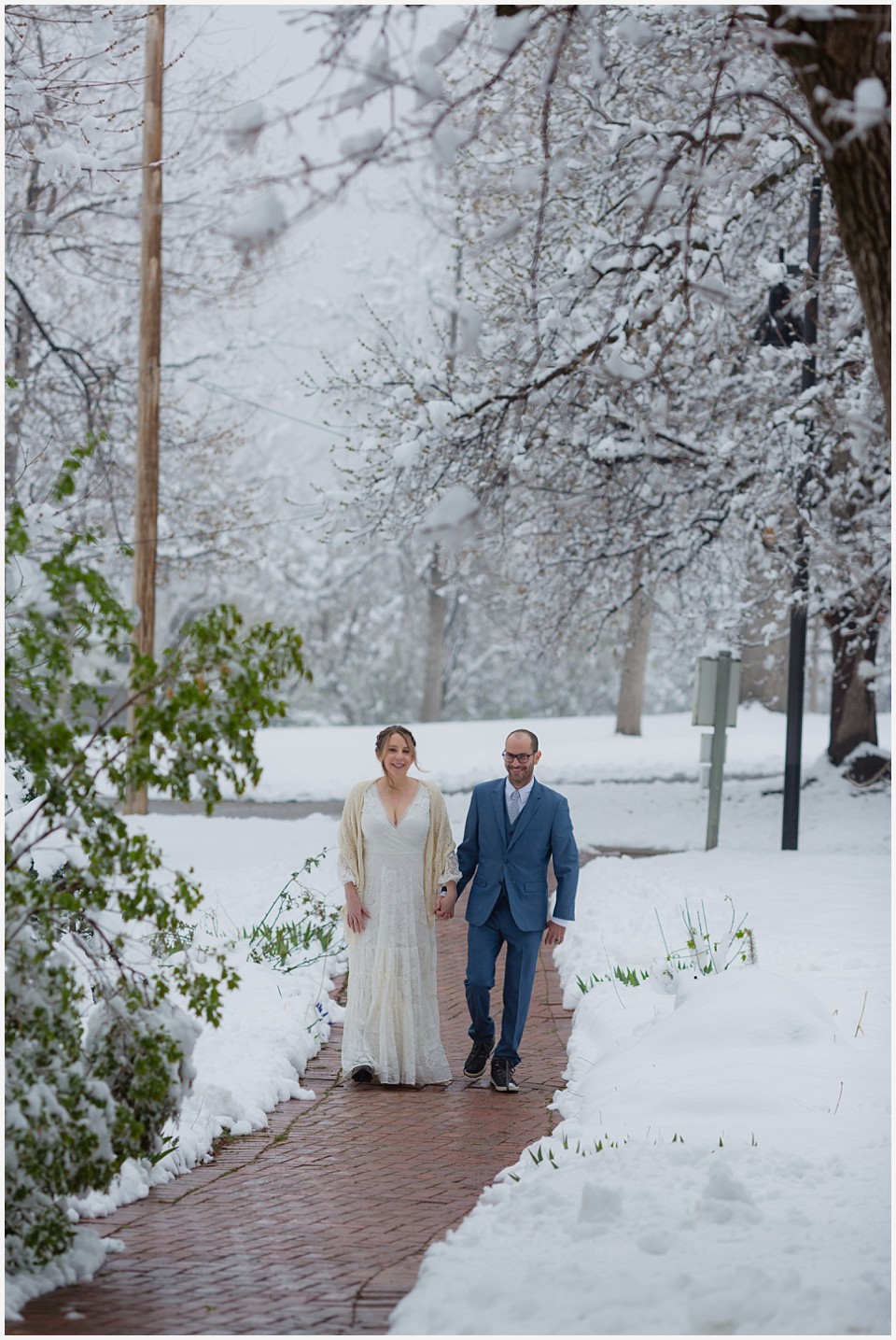 chautauqua community house wedding bride and groom walking in snow covered trees