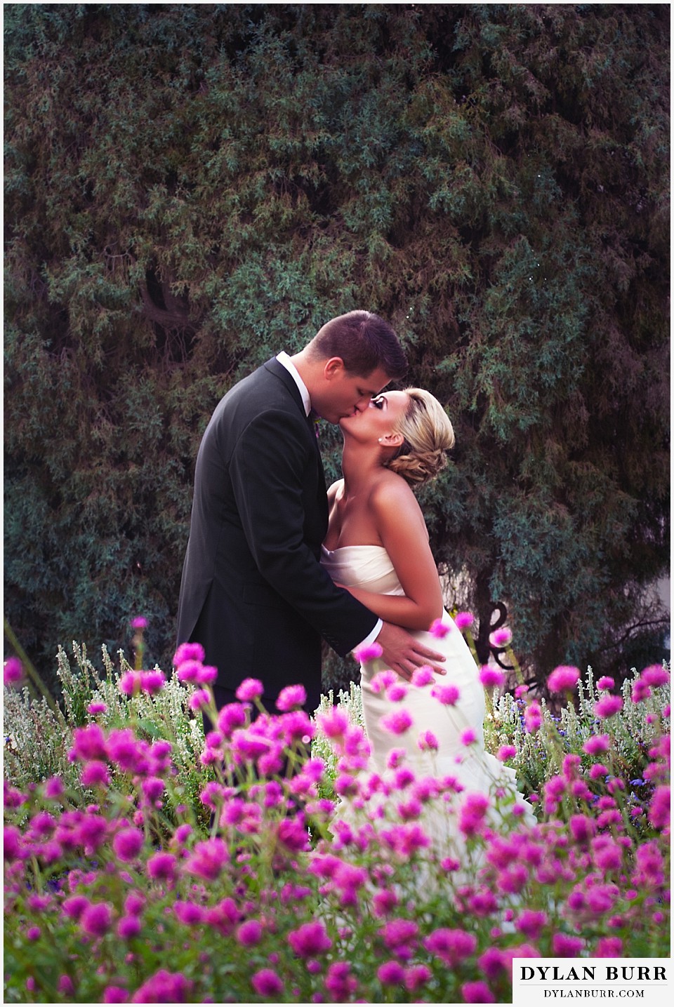 cheesman park pavilion wedding bride and groom kissing in flowers
