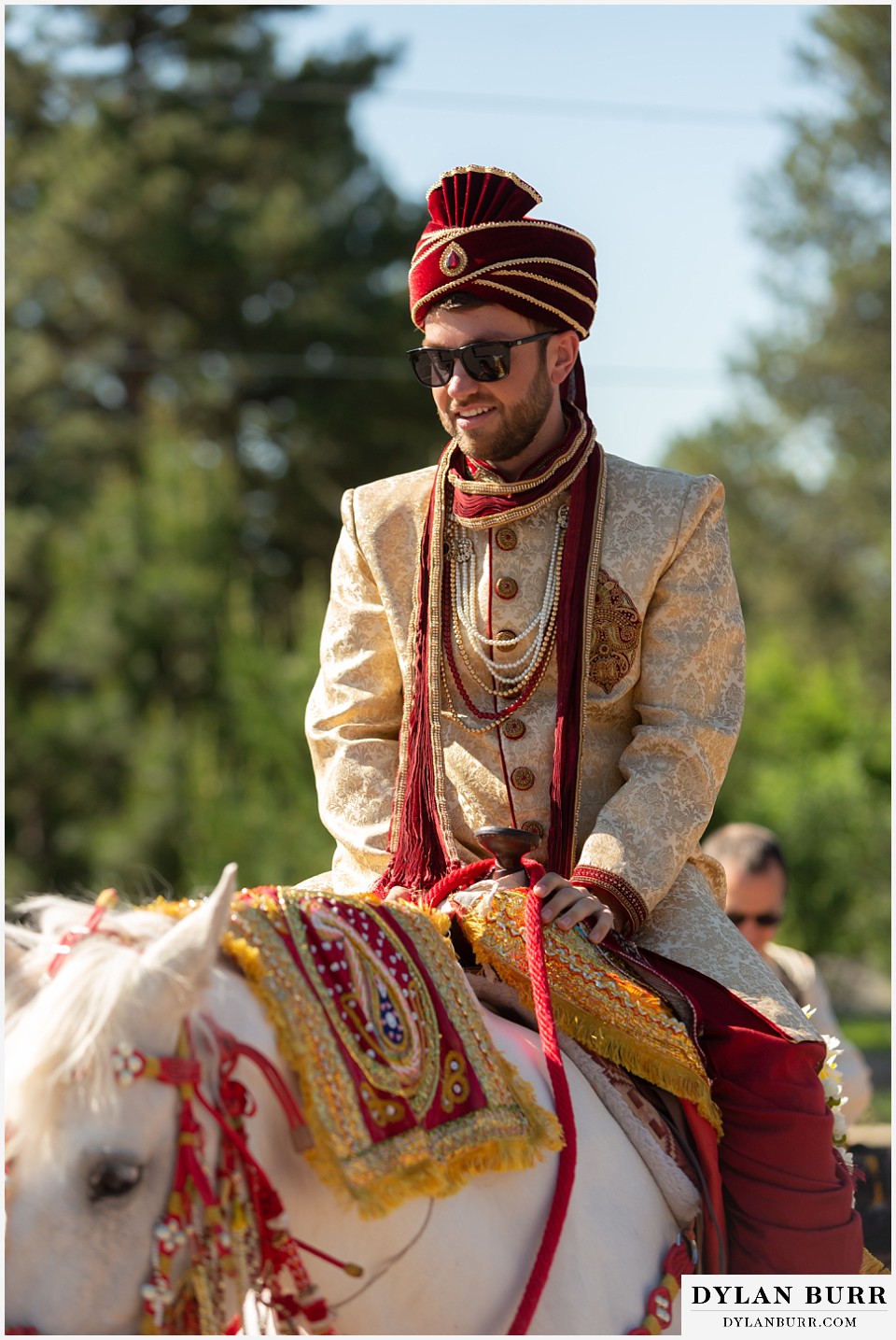 cielo at castle pines wedding colorado mountain wedding groom riding on horse hindu wedding barat