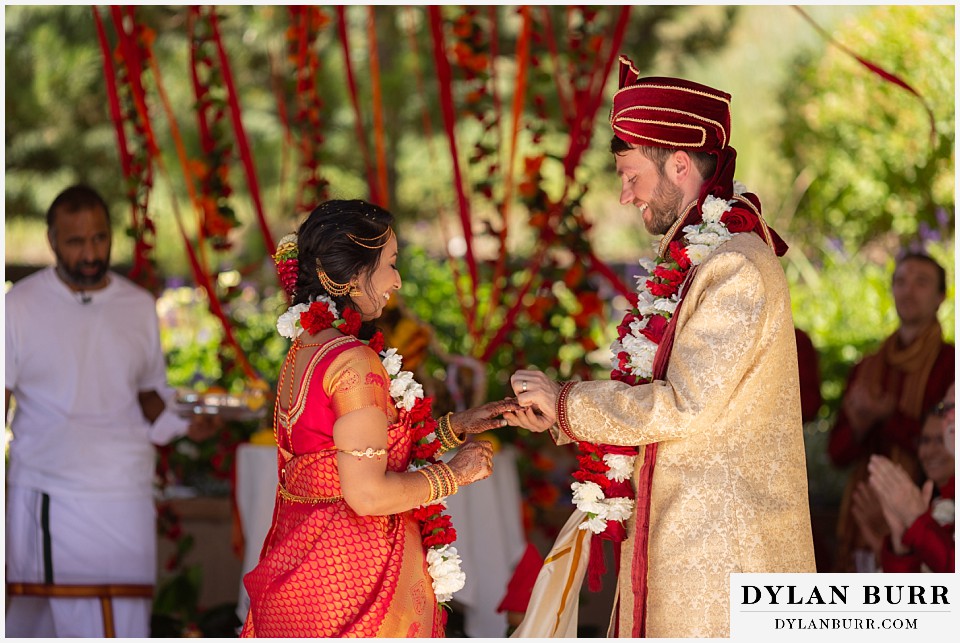 cielo at castle pines wedding colorado mountain wedding bride and groom exchanging rings hindu ceremony