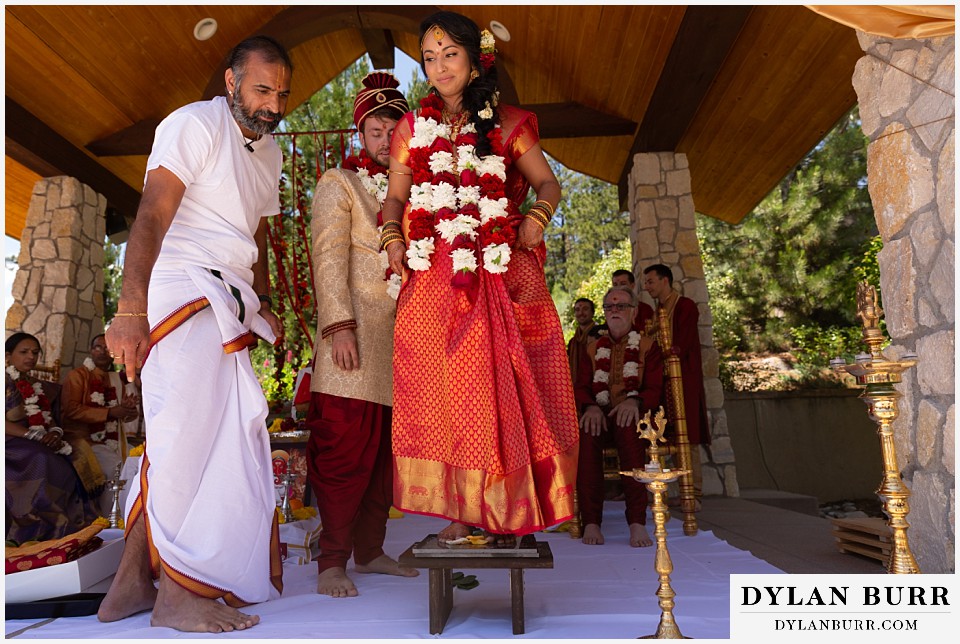 cielo at castle pines wedding colorado mountain wedding bride standing on platform during hindu ceremony