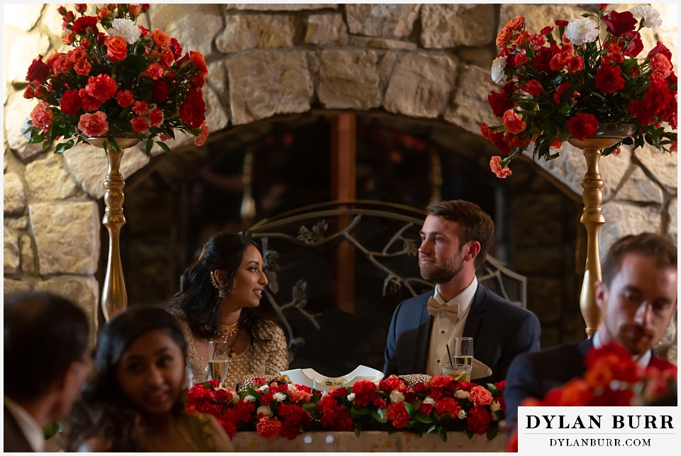 cielo at castle pines wedding colorado mountain wedding bride and groom at head table hindu wedding reception