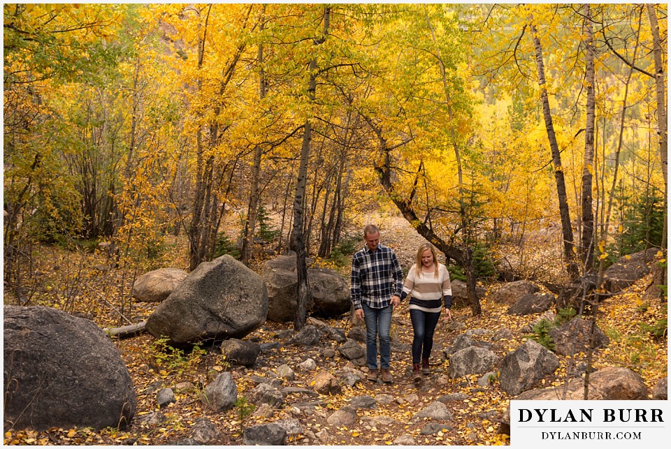 engagement photos in colorado couple hiking up rocky mountain trail