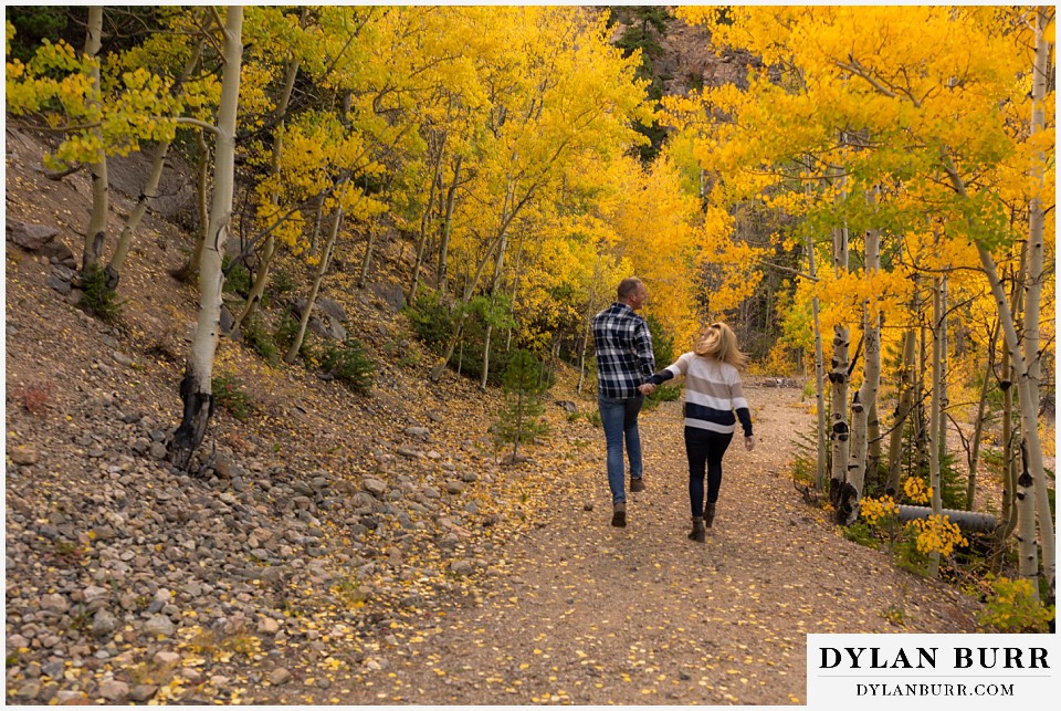 engagement photos in colorado couple dancing down the trail