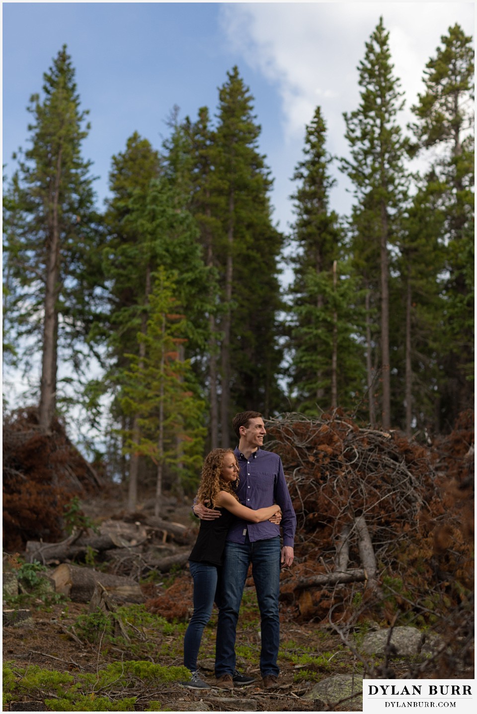 colorado mountain enagagement photo session couple standing together in stacks of pine trees