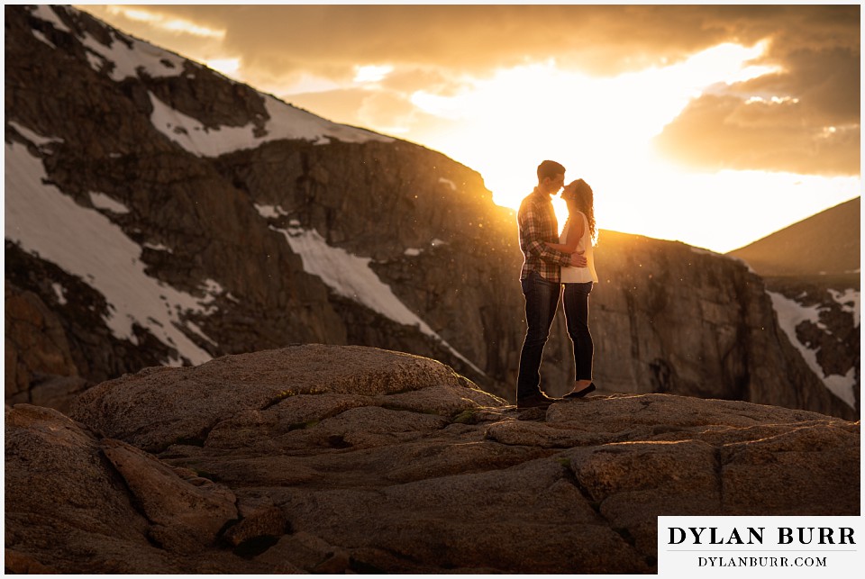 colorado mountain enagagement photo session couple standing together at sunset