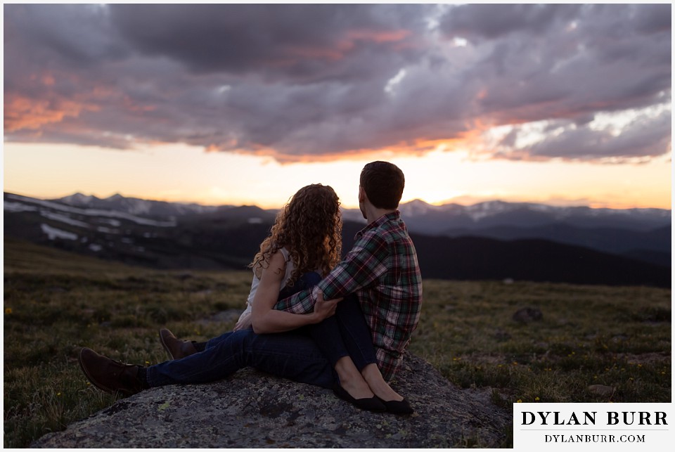 colorado mountain enagagement photo session couple watching sunset from the top of a mountain